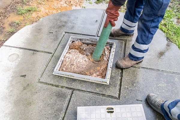 during cesspool pumping, a truck will remove the accumulated waste from the cesspool using a powerful vacuum system